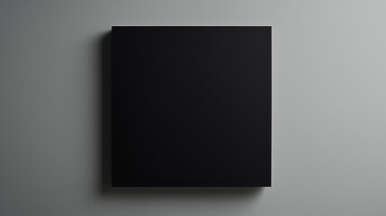 A single black square placed slightly off-center on a gray background.