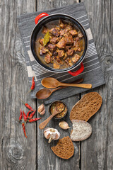 beer braised pork stew in a red pot