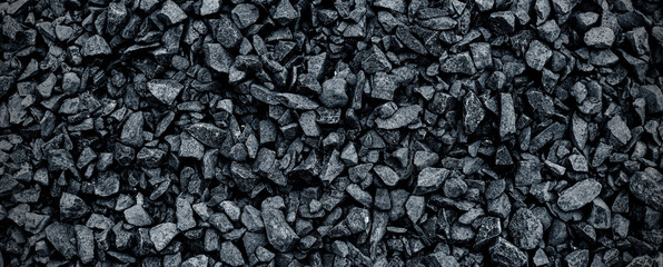 Black volcanic stone. Surface of basalt or granite close-up. Dark rough and textured rock.