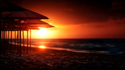 Sunset Over Beach with Parasol Silhouettes and Golden Light on Sand