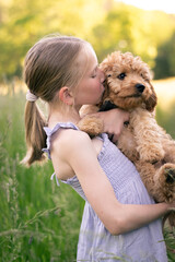 Girl with her cavapoo puppy in her arms