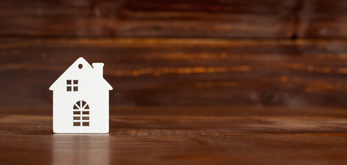 White house shape on wooden background, mortgage loan banner or background with copy space