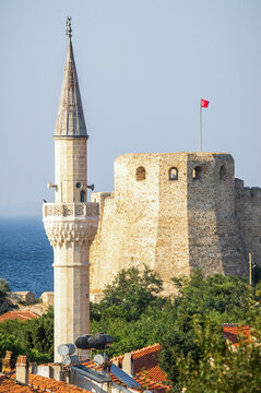 View of the historic Bozcaada Castle and a stone mosque minaret over village rooftops, Bozcaada Island, Turkey