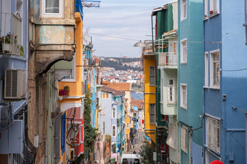 Colorful historic houses with ornate windows in Balat, Istanbul. Touristic district, attractions with historical sites. Colorful streets in Balat. Local and foreign tourists like this place