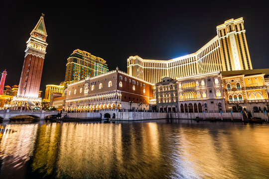 Macau- September 25, 2019: Beautiful night view of Venetian Gothic-style buildings in Cotai, Macau with beautiful reflections of the majestic buildings in the water, owned by the American Las Vegas Sa