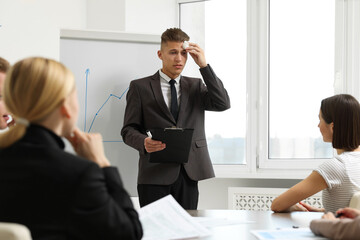 Glossophobia. Man with paper tissue and clipboard feeling embarrassed during business meeting in...