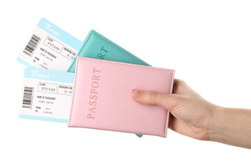 Travel agency. Woman holding flight tickets and passports on white background, closeup