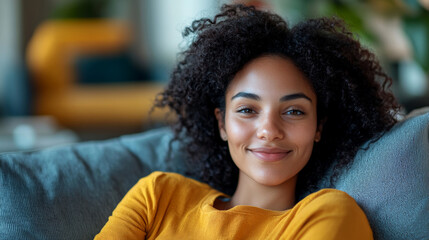 Smiling Woman Relaxing on a Couch at Home in a Cozy Living Room During the Afternoon