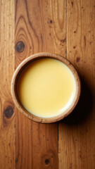 Beef Tallow in a bowl on a wooden table.
