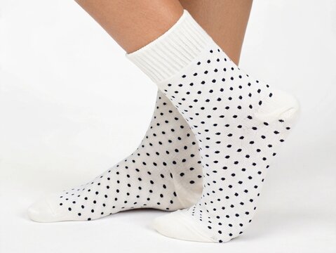 top view white socks with polca dot motif isolated white background for your fashion business design needs