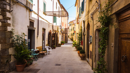 Typical tine italian streets somewhere in tuscany town of Scansano evokes peaceful and calm genius loci where you can retreat from the hustle during summer vacation in medieval town with slow life.
