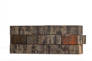 Rustic weathered bricks in various shades with textured surface on white background