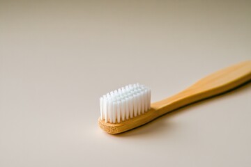 Natural bamboo toothbrush resting on smooth surface highlights e