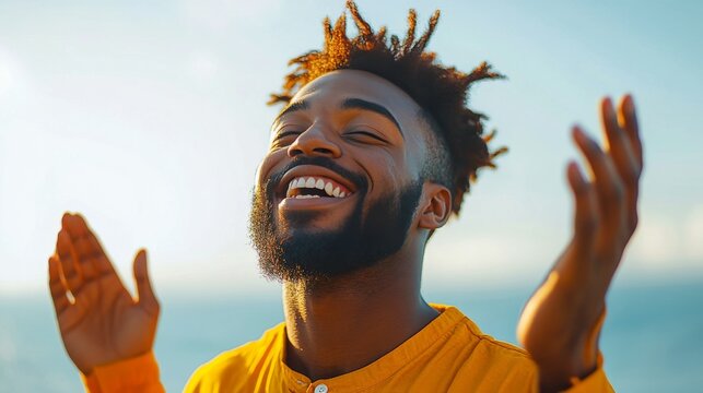 Man expressing joy and freedom by the ocean during sunset in a warm and vibrant atmosphere