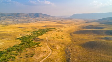 Fototapeta premium Aerial view of vast arid plain in mountainous desert landscape at dusk
