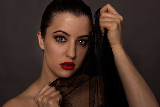 Woman with professional makup headshot in studio with grey background