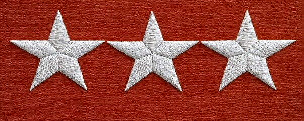 Three Embroidered White Stars on Red Fabric Background Textile Craft Design