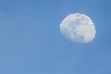The moon in the daytime sky before dusk