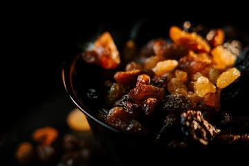 Mixture of assorted raisins in a dark bowl showcasing the rich textures and colors of dried fruit