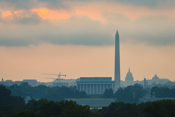 Washinton DC skyline with major monuments including Lincoln Memorial and Washington monument and the capitol in sunrise