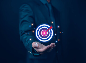 Businessman holding virtual target icon for business purpose. Strategic planning for business growth. Business goal setting concept, marketing strategy and target for success.