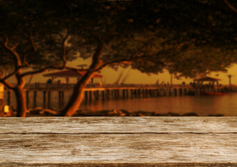 Wooden table top on the beach or sea.Party on the beach  sunset time concept.For montage product display or design key visual layout.View of copy space.