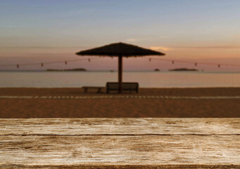 Wooden table top on the beach or sea.Party on the beach  sunset time concept.For montage product display or design key visual layout.View of copy space.