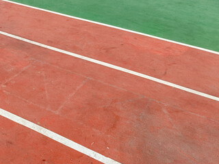 Aerial View Of Red Running Track With Green Field And White Lane Markings Using Synthetic Materials