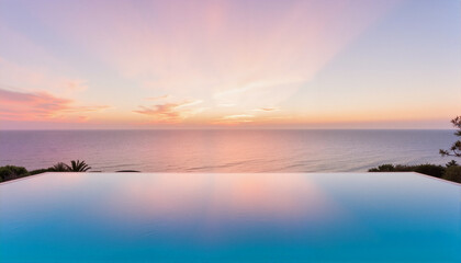 Obraz premium Stunning infinity pool reflecting pastel sunset over ocean for travel blogs, vacation websites, luxury real estate, resort marketing, and inspirational design projects