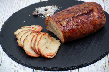 Washed flour seitan, vegan glazed ham sliced on black slate stone