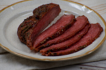 Vegan steak made with gluten and spices, sliced on ceramic plate
