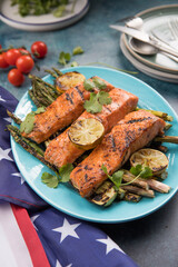 Grilled Salmon with asparagus, zhuccini on blue plate. Celebrating Independence Day, July 4.