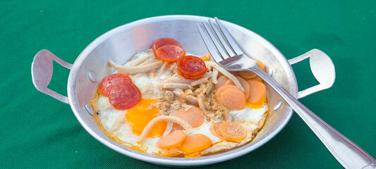 pan-fried egg with pork and toppings. Breakfast food in Thai style