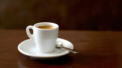 Double Espresso Served with a Small Spoon on a Saucer
