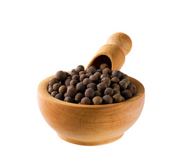 allspice or Jamaican pepper seeds in a wooden bowl isolated on white background.