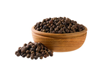 allspice or Jamaican pepper seeds in a wooden bowl isolated on white background.
