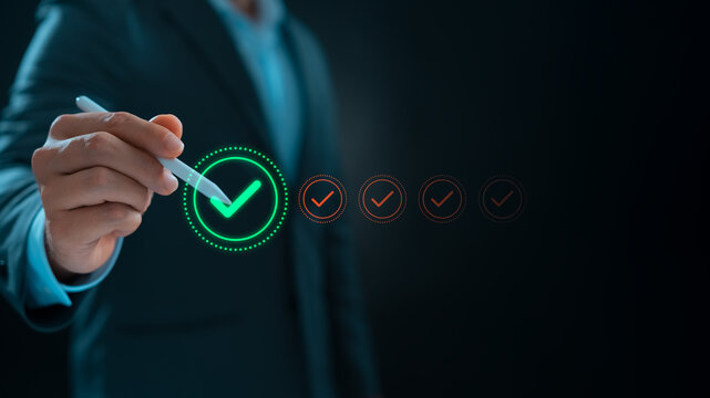 Businessman makes a checklist Assessment and questionnaire, Businessman using stylus pen to do online survey online digital form Show green check mark Choose the correct answer on the exam.