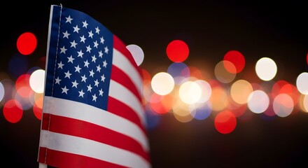 American flag waving against a celebratory bokeh lights background at night