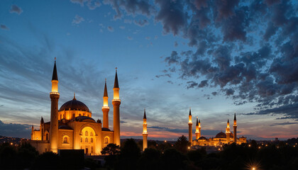 Illuminated mosque and minarets against twilight sky for architectural and cultural landmark concept