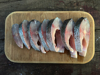 silver carp steak on a wooden cutting board