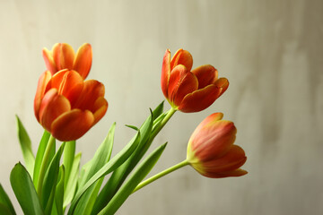 Bouquet of orange tulips on wooden table, closeup