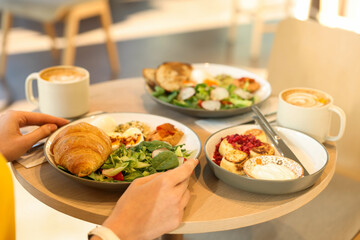 Woman having tasty breakfast in cafe, closeup