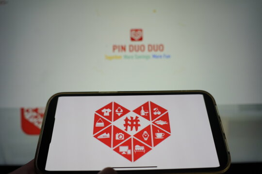 Roosendaal, The Netherlands - February 15, 2025: A mobile phone displaying the logo of Pinduoduo, with the company website in the background.