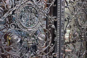 Ornate wrought iron gate with historical motifs
