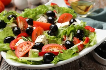 Delicious fresh Greek salad on wooden table, closeup