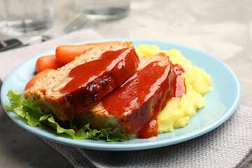 Delicious baked turkey meatloaf with mashed potato served on table, closeup