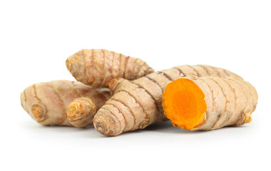 Whole and cut turmeric roots isolated on white