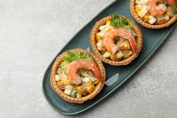 Tartlets with delicious filling on grey table, top view