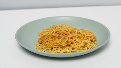 a plate of fried noodles on a white background