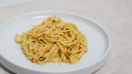 a plate of pasta noodles with a layout on a white background